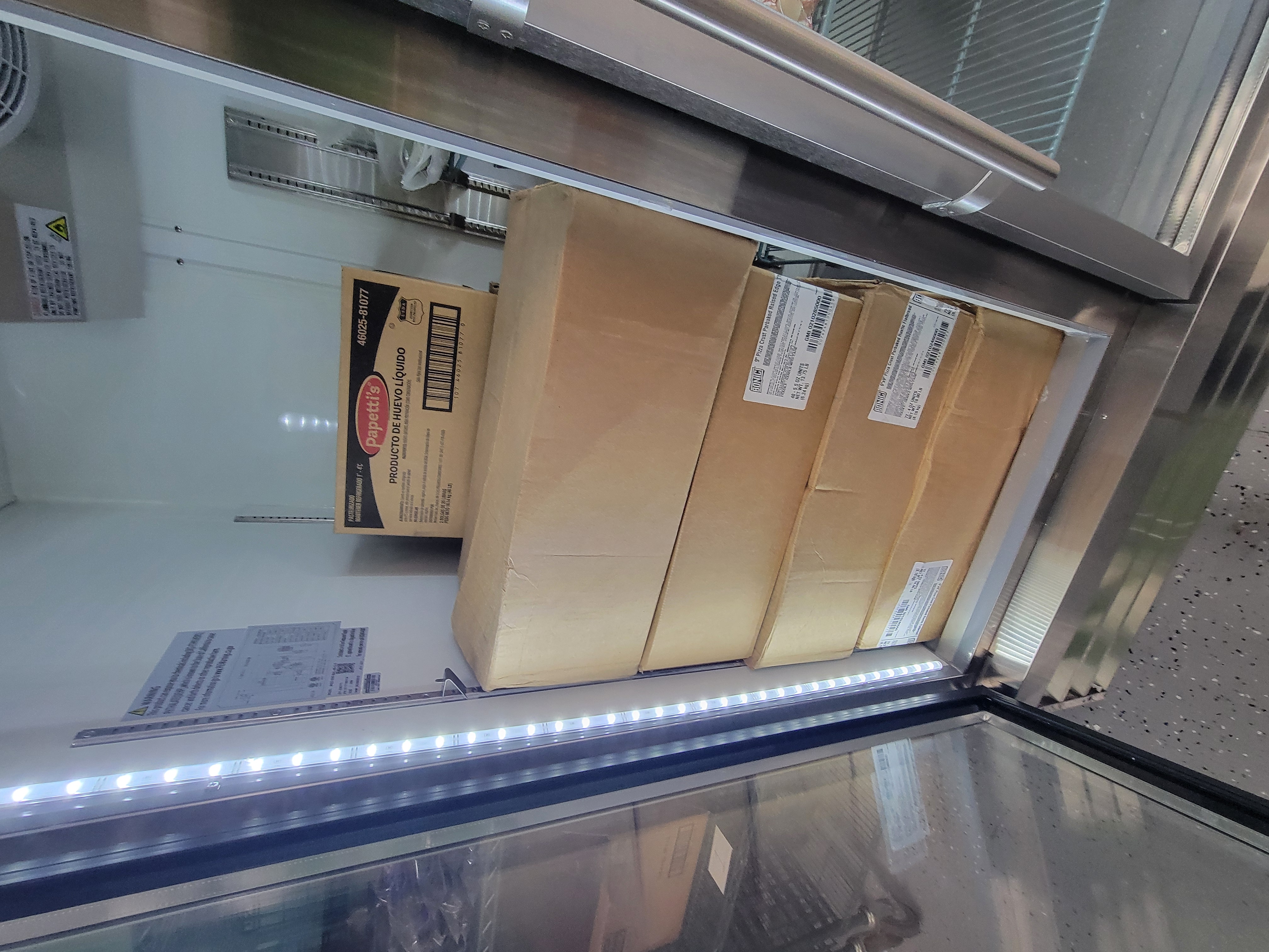 Boxes in a fridge stacked on each other.